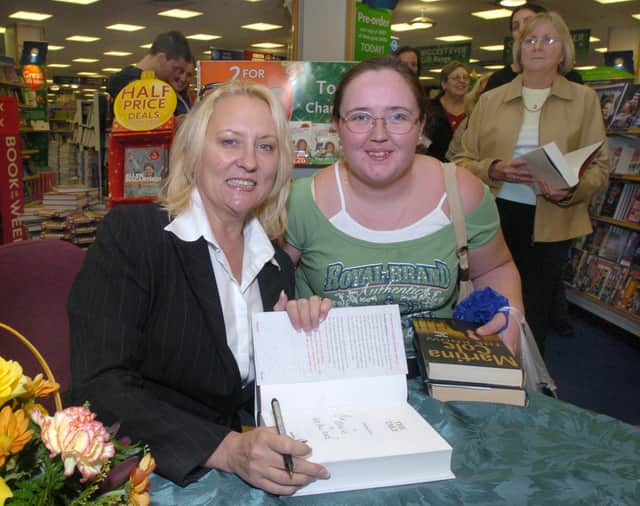 Pictured at W H Smiths, Meadowhall, where writer Martina Cole was seen signing copies of her book The Take. With her is fan Maria Oflaherty from Wincobank, Sheffield.