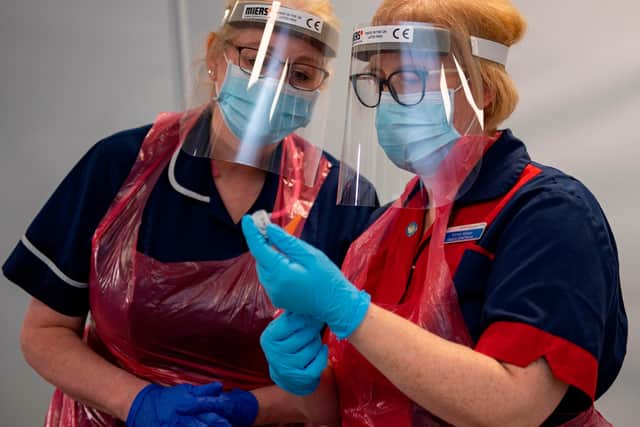 Nurses prepare the first doses of the Pfizer-BioNTech COVID-19 vaccine at the Northern General Hospital in Sheffield (Photo by ANDY STENNING/POOL/AFP via Getty Images)