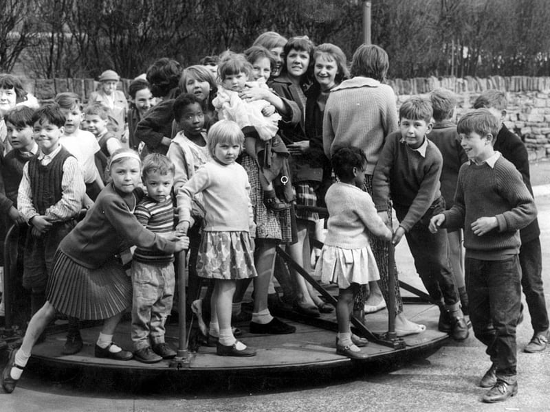 How many children can you get on a roundabout? Pictured at the Countess Road playground, Sheffield, on April 24, 1962