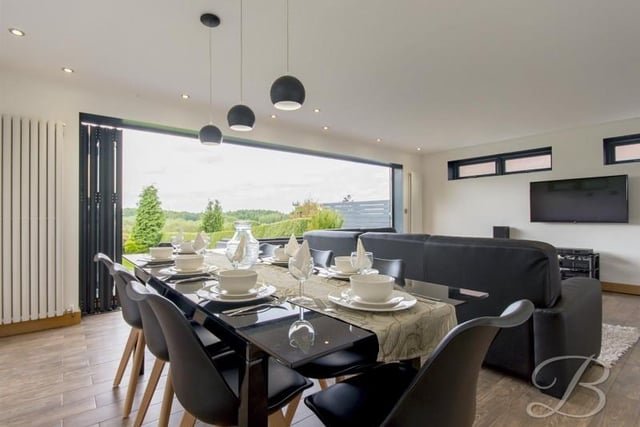 This reception room is open plan with the kitchen, creating a "fabulous sense of space and again, perfect for anyone who enjoys entertaining".