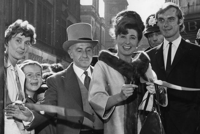 Actress Pat Phoenix, who played Elsie Tanner in Coronation Street, cuts the tape to officially open Top Clothing Store in King Street.