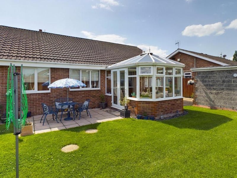 Rear garden - Fence enclosed, laid to lawn with raised flower beds, paved path and patio area. External lighting and garden tap.