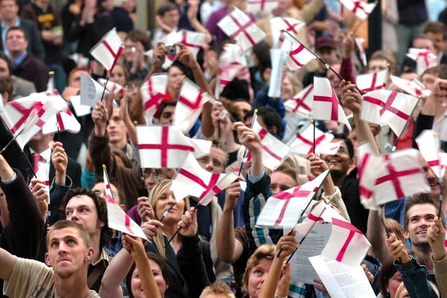 England fans wave their flags at a civic reception for Michael Vaughan in Sheffield