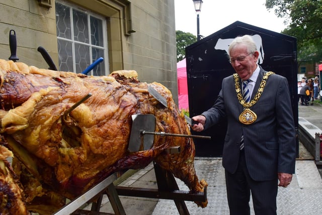 The Mayor of Sunderland Coun. Harry Trueman cuts the first slice from the roast ox at the Houghton Feast parade on Saturday.