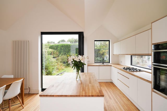 The exceptional modern finish to this property is encapsulated in the kitchen, with clean white appliances reflecting the abundance of light from the floating corner window to all corners of the room.