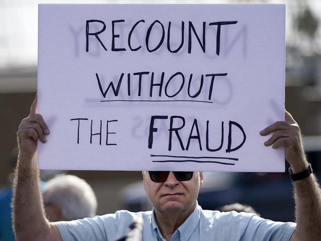 A supporter of President Donald Trump attends a rally outside the Maricopa County Recorder's Office (AP Photo/Ross D. Franklin)
