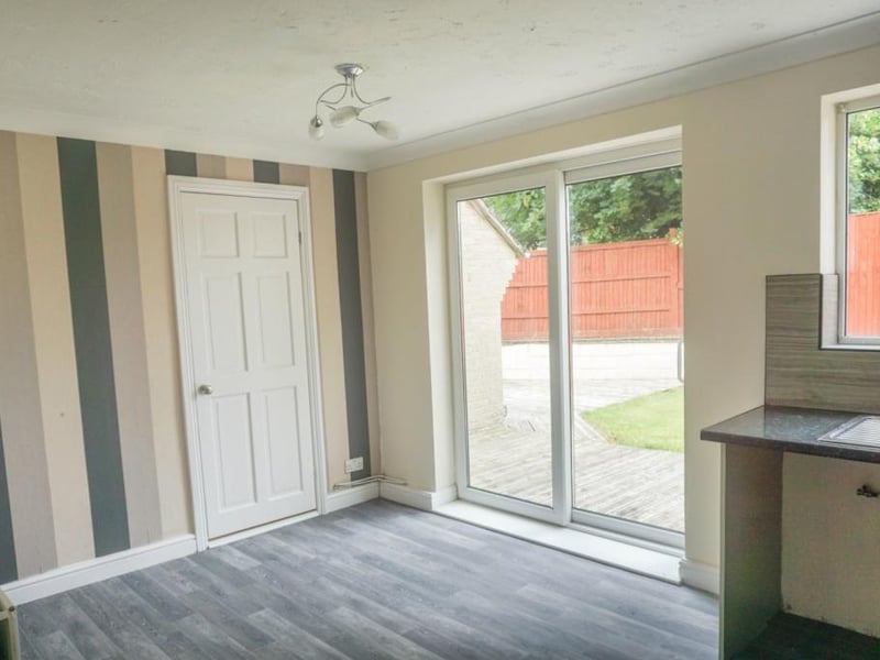 Modern kitchen/dining area with patio doors leading to the rear garden