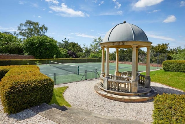 So plentiful are the sports and leisure facilities at Robbie Williams's home that he could stage his own Olympic Games! Here are the tennis courts, part of 72 acres of land that also include immaculate gardens and grounds, a walled garden with pavilion, a water feature, paddocks, woodland and even a helicopter hangar.