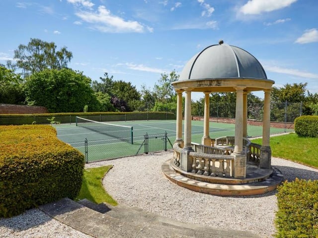 So plentiful are the sports and leisure facilities at Robbie Williams's home that he could stage his own Olympic Games! Here are the tennis courts, part of 72 acres of land that also include immaculate gardens and grounds, a walled garden with pavilion, a water feature, paddocks, woodland and even a helicopter hangar.