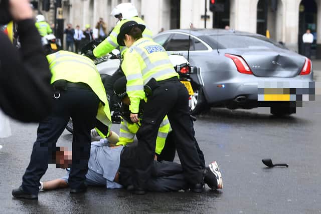Police detain a man after he ran in front of Prime Minister Boris Johnson's car -Victoria Jones/PA Wire