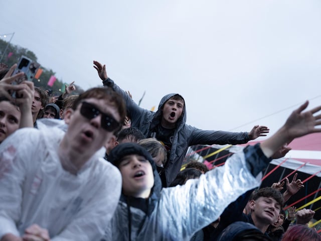 Fans braved wet and muddy conditions.