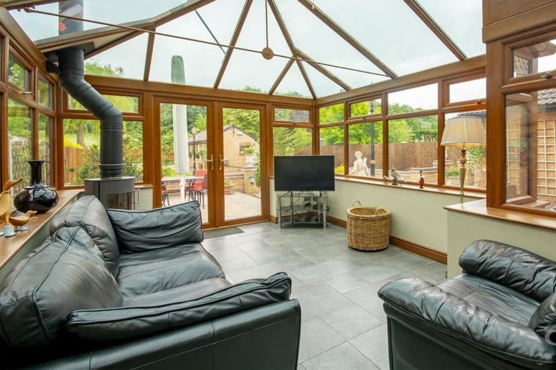 How about this for a luxurious conservatory? Tiled flooring, a log burner, windows overlooking the garden and a glass-panelled roof, allowing for ample natural light.