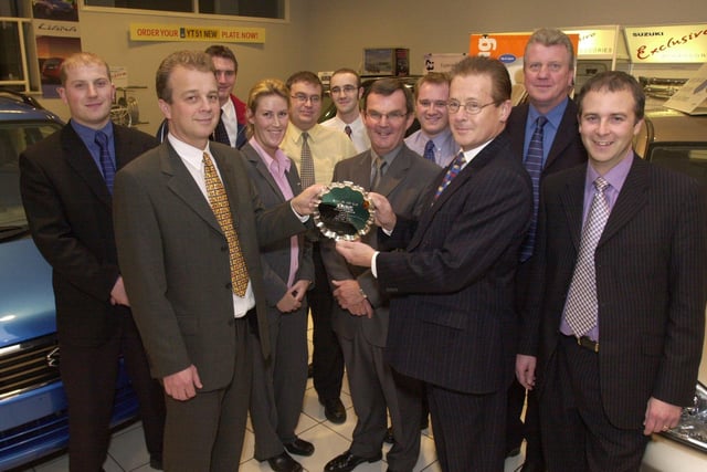 The company received an award from Suzuki for selling the most cars in 2001 for a Sheffield and Chesterfield dealership. Seen are staff at the presentation, as Left  Tony Cordin the Group Autoworld OPerations Manager at Chesterfield as he receives the award from David Seward the Sales and Marketing Director Suzuki  GB.