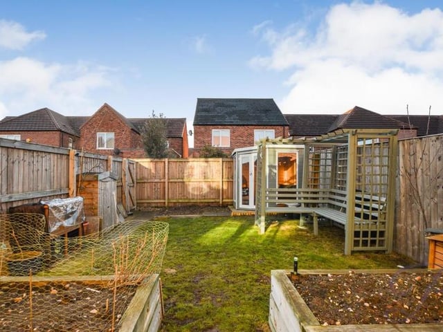 Time to have a look outside now as we move into the spacious garden at the back of the Kingfisher Way property. As well as a lawn and decorative borders, there is lots going on.