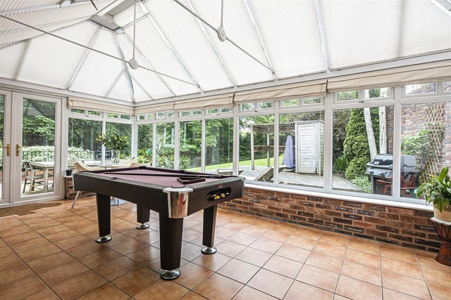 The conservatory and kitchen offer views out over the property's "lovely garden".