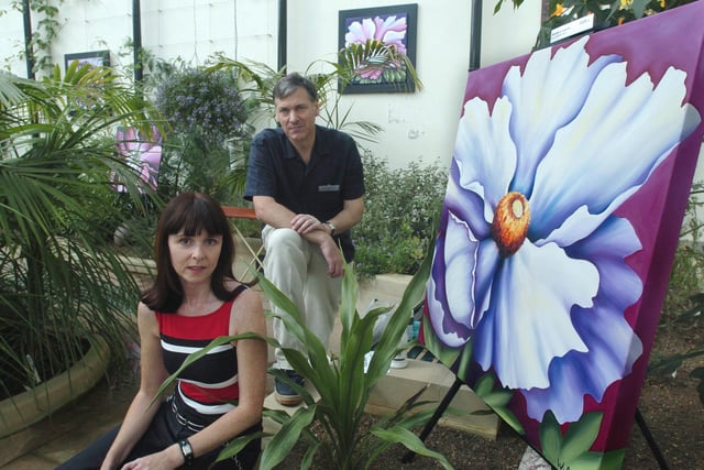 David Middleton, with his artist wife who paints under the name of Wendy Carlton, with some of her work among the tropical plants back in 2004