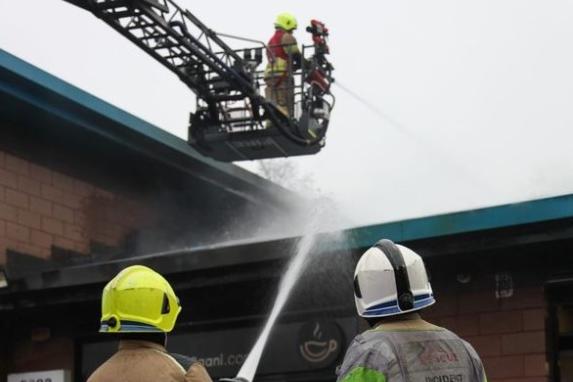 South Yorkshire Firefighters hose down the blaze and hotspots during an emergency fire at the blazing Attercliffe takeaway.