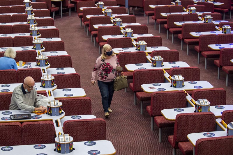 A lady takes a stoll in between the rows of tables at Buzz Bingo.
