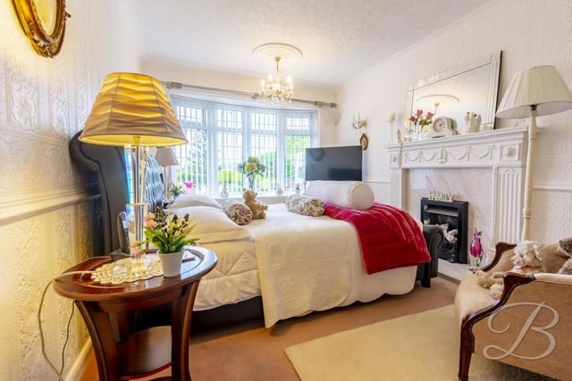 One of the three bedrooms is on the ground floor of the property. It has a feature fireplace, carpeted floor, central-heating radiator and a bay window overlooking the front.