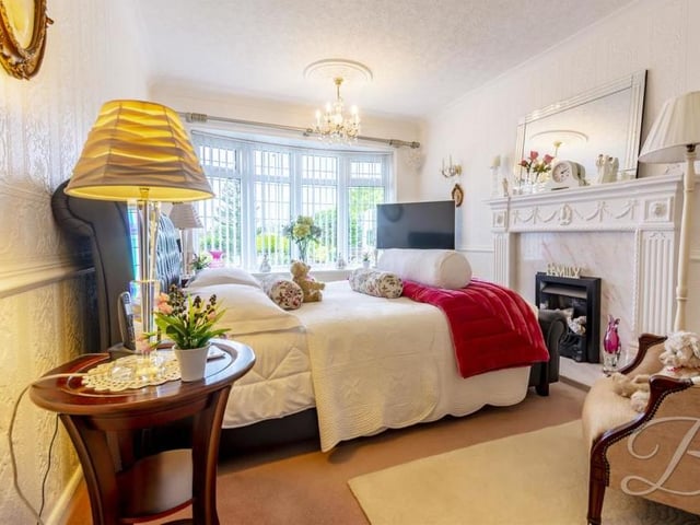 One of the three bedrooms is on the ground floor of the property. It has a feature fireplace, carpeted floor, central-heating radiator and a bay window overlooking the front.