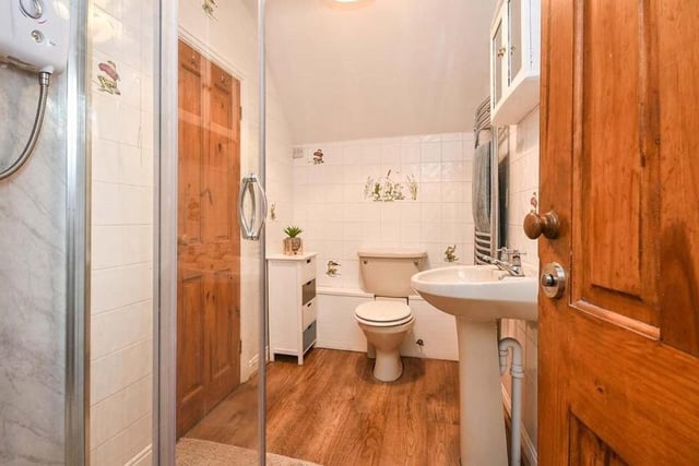 One of the five bedrooms at Halfmoon House has access to its own Jack and Jill en suite. It comprises a shower cubicle, low-flush WC, wash hand basin and laminate flooring.
