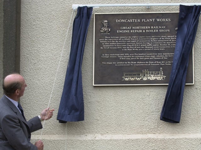 The Duke of Kent unveiled a plaque during his visit Wabtec Rail , Doncaster that celebrated 150 years. The Flying Scotsman, made at the site is behind them.