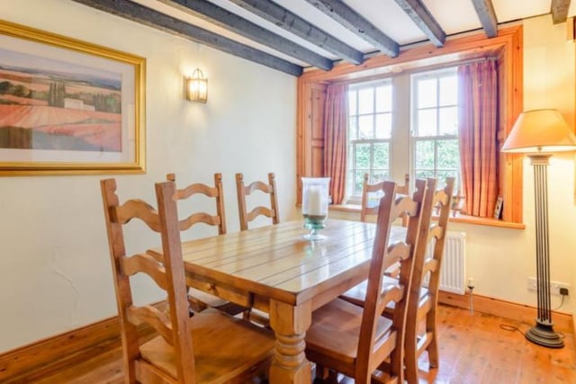 A dining room with stripped wooden flooring and timber beams overhead, providing ideal space for both formal and informal dining. 

Picture: Right Move