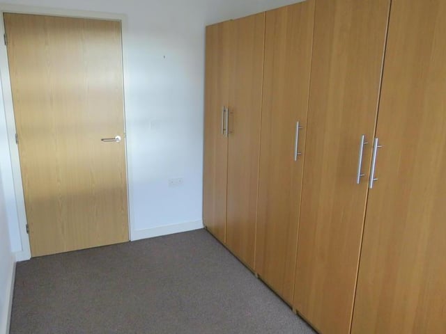 A double room with a front facing double glazed window and a central heating radiator.