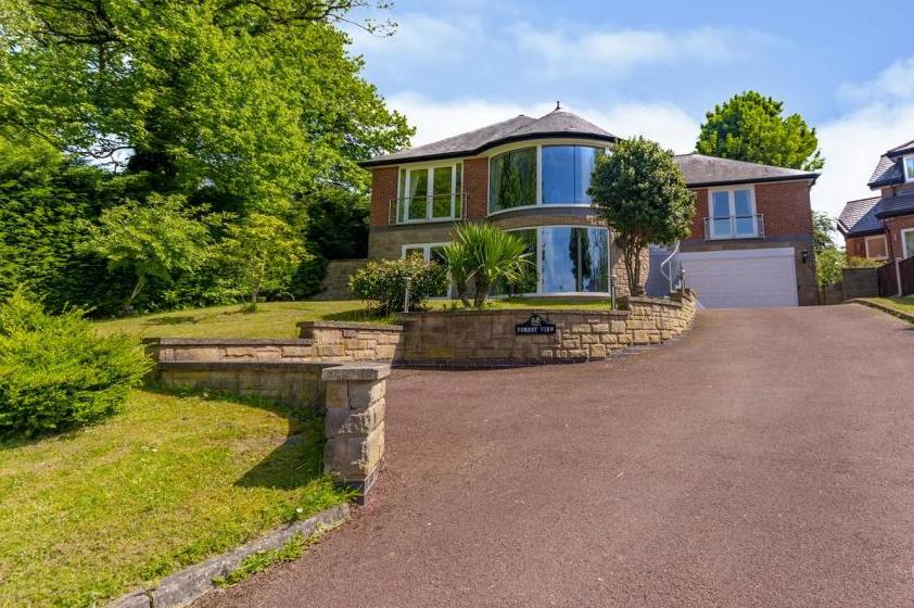 Set back on a large plot, the five-bedroom, detached home boasts a unique exterior. You can't wait to have a look inside, can you?
