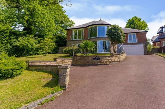 Set back on a large plot, the five-bedroom, detached home boasts a unique exterior. You can't wait to have a look inside, can you?