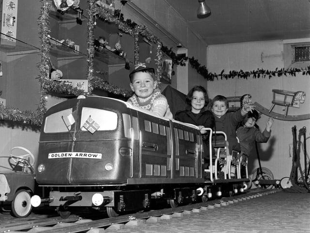 Children play on the model of the Golden Arrow engine in Jenners department store in November 1965.