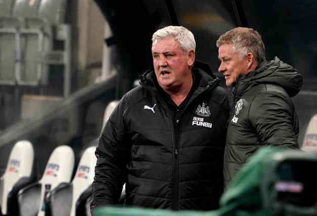Steve Bruce, manager of Newcastle United and Ole Gunnar Solskjaer, manager of Manchester United talk prior to the Premier League match between the two sides at St. James Park