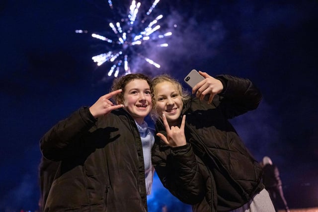 Two girls took a break from enjoying the fireworks to smile and pose for the camera.