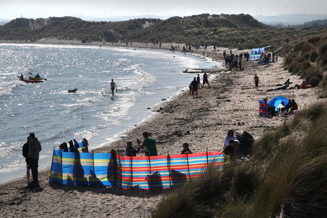 Sun-bathing and water sports at Beadnell Bay at Easter 2019.
 Picture by Jane Coltman