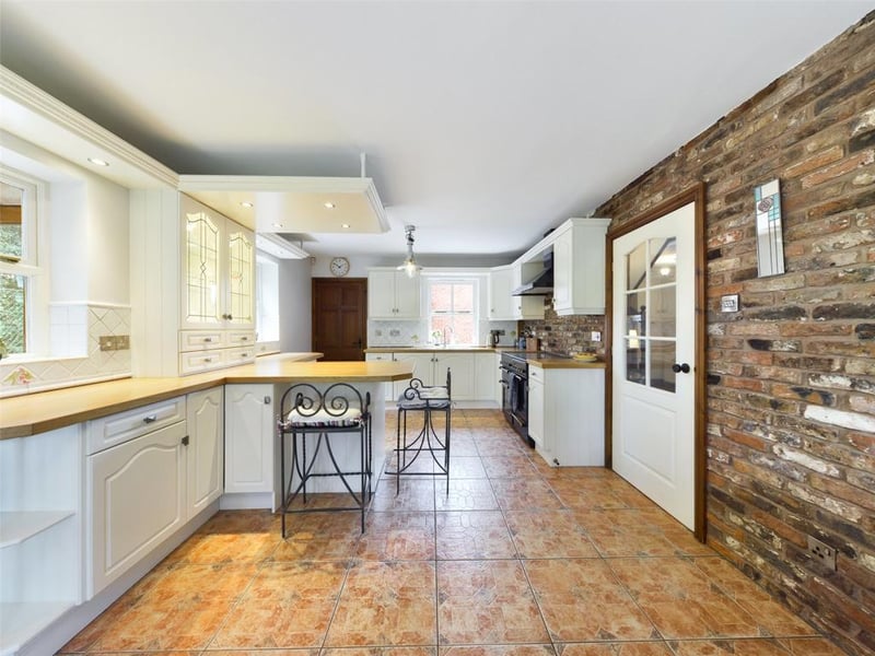 a range of attractive wall and base units with complementary work-surfaces, integrated dishwasher, integrated fridge, extractor hood, gas cooking range. Parquet Herringbone wood flooring to the dining area, French style doors to the rear elevation and a bare brick feature wall