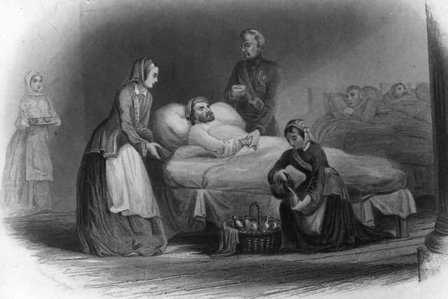 British nurse and hospital reformer Florence Nightingale, standing left, nursing wounded soldiers during the Crimean War