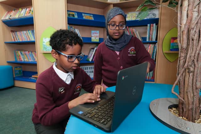 Pupils at Abbeyfield primary School  with their new Chromebooks. Research suggests as many as six per cent of UK households remain offline.