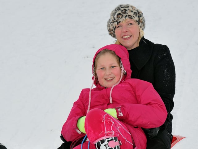 Maise Reed and her mum Michelle Williams sledging in the snow on top of Portsdown Hill.