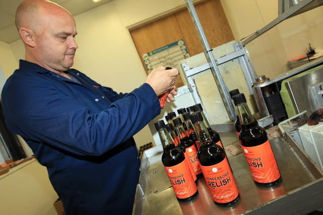 Henderson's Relish in Sheffield adopted a new label in 2015. Paul Carter is pictured attaching them on the factory production line.