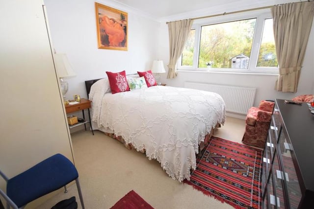 The main bedroom is described by the estate agents as "having a tranquil, relaxed atmosphere". Its window looks out to the back of the bungalow and there is access to an en suite bathroom.