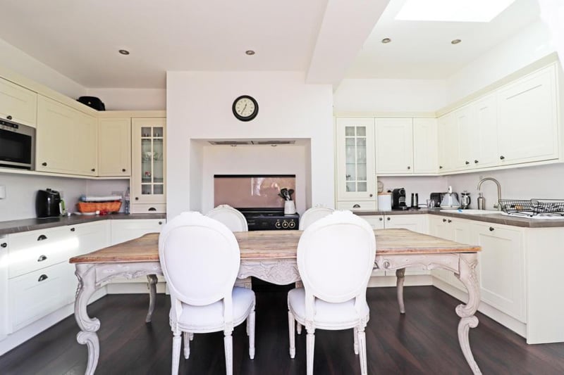 The kitchen is flooded with light thanks to the sky light and has French doors leading to the outside.