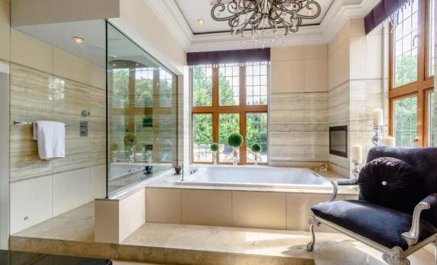 The bathroom offers incredible views of gardens as well as an option for an incredible bath or standing shower
