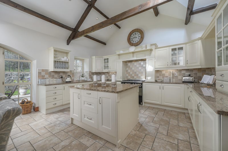 The kitchen offers a quality range of fitted base and wall units, with a vaulted ceiling and exposed timber beams giving this room a fantastic farmhouse feel.