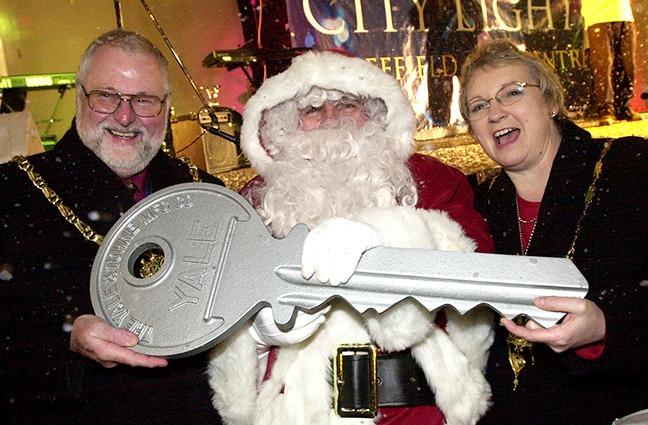 The Mayor and Mayoress, Councillor David Baker and Penny Baker, give Santa the keys to open all the houses in Sheffield on Christmas Eve at the switch on of the Sheffield city centre Christmas lights on November 14, 2001