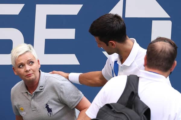 Novak Djokovic tends to a line judge who was hit with the ball during his US Open match against Pablo Carreno Busta. Photo by Al Bello/Getty Images