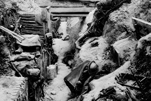 1916 showing a British soldier keeping watch on 'No-Man's Land' as his comrades sleep in a captured German trench at Ovillers, near Albert, during the Battle of the Somme in the 1914-1918 First World War. PA Photo.