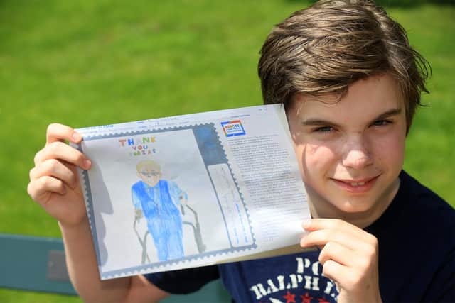 Danny Whiteland, 12, designed a stamp in the honour of Captain Tobias for the Royal Mail 'Covid Hero' competition. Picture by Chris Etchells