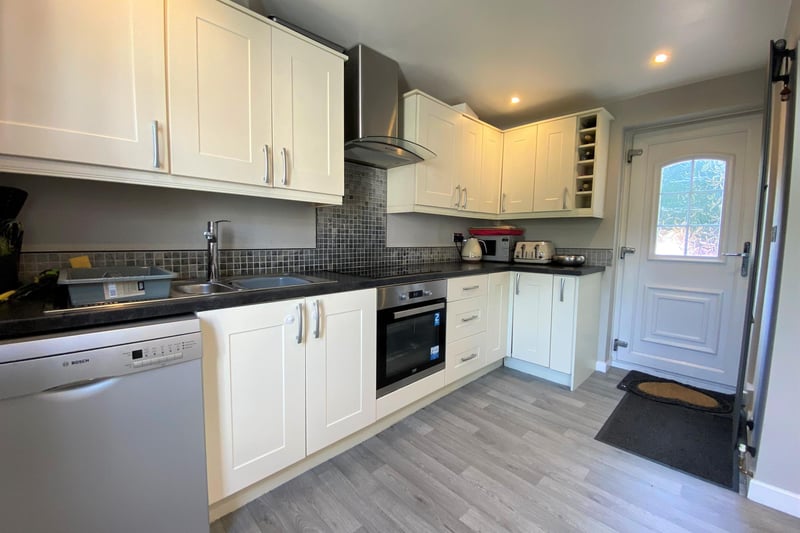 The breakfasting kitchen has a range of wall/base units and complimentary worktops.
