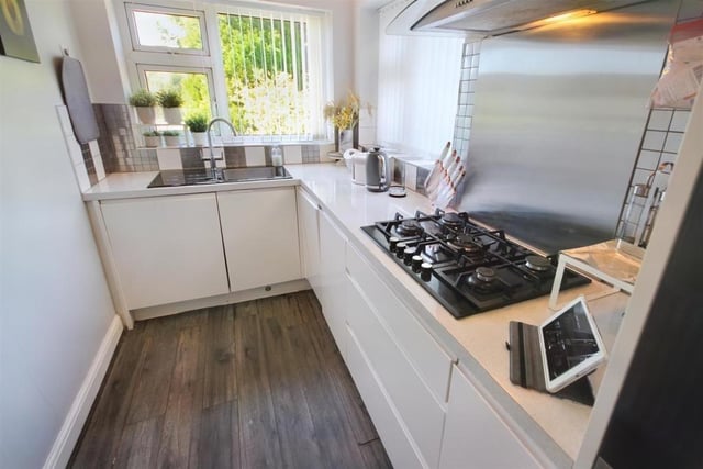The kitchen has been wonderfully finished with a modern style. It's bright and the white cupboards reflect the light back as well, making it appear even brighter.