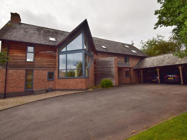 A neatly-designed car port, attached to the house, provides ample parking space. There is also a single garage with up-and-over doors, power and light.